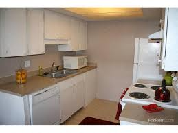 a white kitchen with a stove and a sink